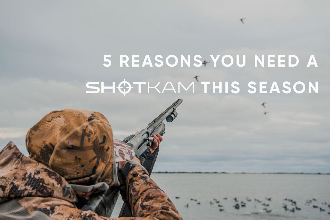 Camo-clad waterfowl hunter pointing shotgun at birds in flight with ShotKam attached.