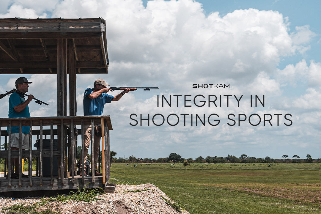 ShotKam showcases integrity in shooting sports with two individuals focusing on clay targets at a European shooting range.