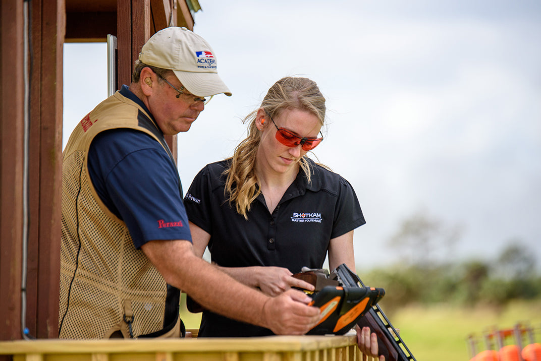 European sporting clays instructor and student reviewing ShotKam footage, discussing challenges of interpreting lead.