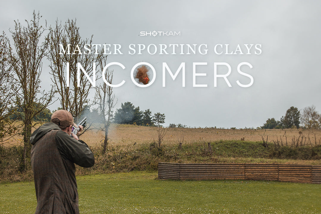 Sporting clays shooter aims at an incoming clay pigeon, featured in ShotKam’s coaching series on handling incomer targets.