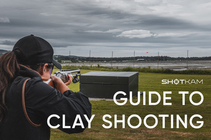 Clay shooter tracking a flying target with a ShotKam-equipped shotgun