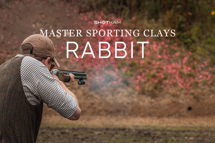 Sporting clays shooter using a shotgun to break a rabbit target with ShotKam footage.